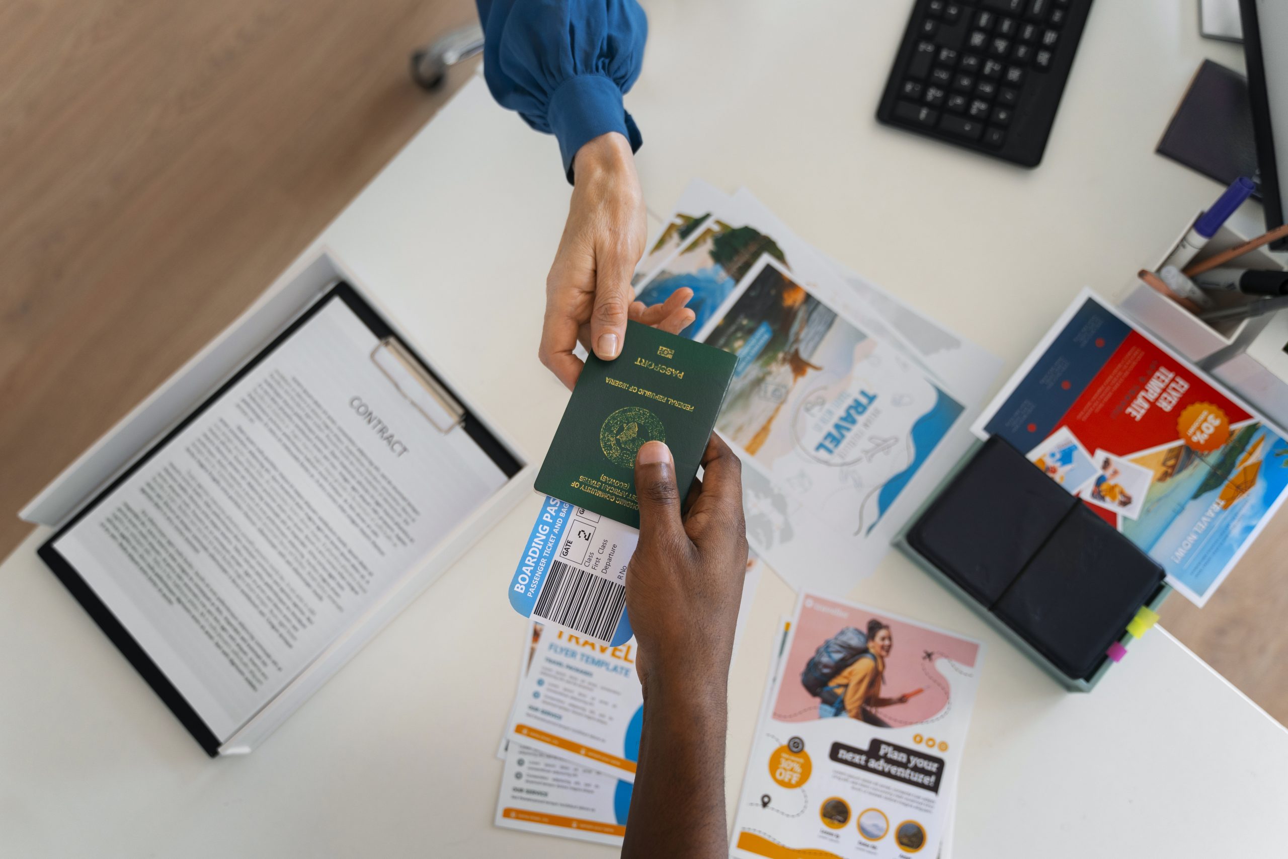 top-view-hands-holding-travel-documents